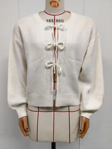 Knit cardigan detail view featuring cute front bow ties, soft fabric and comfortable long sleeves.