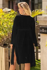 Close-up back view of black sun protection cover-up with crochet hollow waist detail