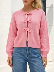 Pink knit cardigan with cute bow tie closure, stylish and cozy women's daily autumn wear.