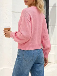 Pink knit sweater detail showcasing the cozy long sleeves and elegant back design for women.