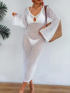 Elegant white crochet beach cover-up with hollow mesh design and deep V-neckline.