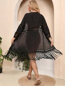 Macro view of the black beach cover-up showing back tassel details and mesh texture