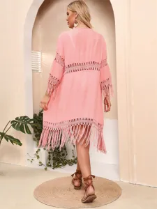 Back view of pink bohemian beach cover-up with crochet lace and tassel fringe details
