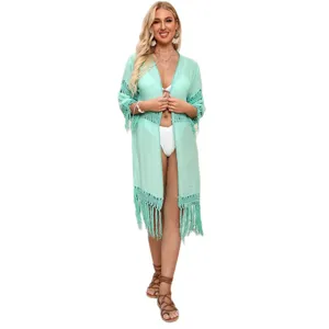 Elegant mint green crochet long beach cover-up featuring stylish tassel fringe details