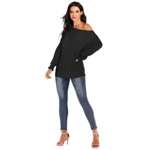 Maglione nero da donna con spalle scoperte maniche a pipistrello e jeans skinny attillati.