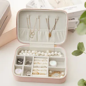 Portable pink jewelry box organizer with multi-functional slots for rings and necklaces