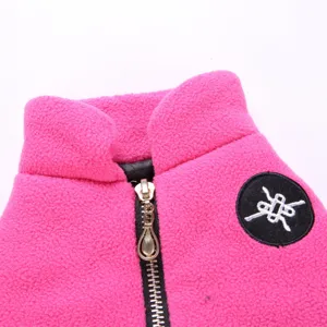 Pink pet fleece clothing zipper detail close-up, warm winter dog apparel fabric texture.