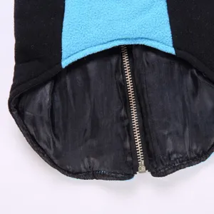 Pet fleece jacket detail view featuring black and blue color block and soft lining.