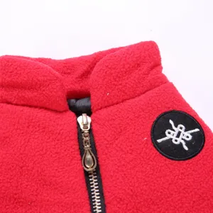Red fleece pet jacket collar zipper closeup detail showing soft fabric and hardware.