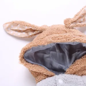 Detailed view of cute bunny ears pet winter coat for small dogs fluffy warm dog apparel.