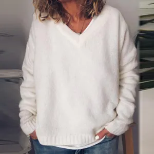 Detail view of the cozy white V-neck knit sweater, showing soft texture and relaxed fit style.
