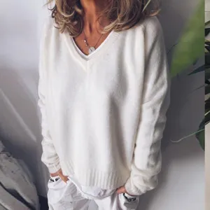 Casual loose V-neck knit sweater for women, solid color soft warm winter pullover top.