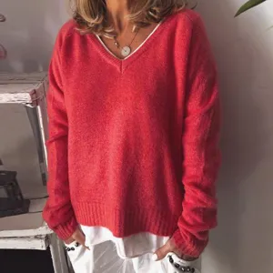 Red V-neck knit sweater for women, cozy loose pullover top, perfect autumn winter fashion detail.