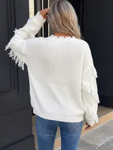 Back view detail of white loose knit sweater featuring fringe sleeves and distressed neckline trim.