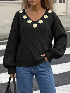 Black knit sweater featuring V-neckline, 3D floral appliques and relaxed lantern sleeves.