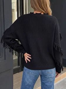 Detailed view of black knitted pullover sweater featuring fringe sleeves and raw neckline.