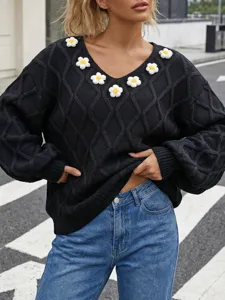 Black argyle knit sweater featuring 3D handmade floral appliques and stylish lantern sleeves.