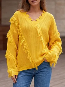 Detail view of a vibrant yellow V-neck knitted sweater featuring playful fringe and tassel accents.
