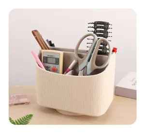Close-up of a rotating desktop organizer with multiple compartments holding various items