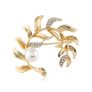 Elegant vintage gold leaf branch brooch with sparkling crystals and large white pearl