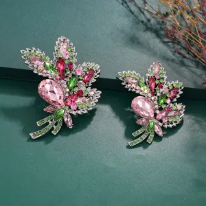 Detailed macro view of two vintage luxury crystal brooches in leaf design