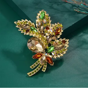 Close-up detail of luxury vintage leaf brooch with colorful crystals and rhinestones