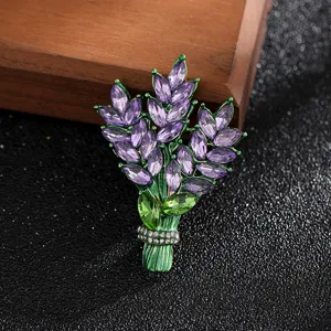 Detailed macro view of an elegant purple crystal wheat brooch with green enamel finish