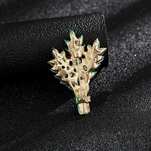 Back view of a vintage gold-toned leaf brooch showing secure pin fastener