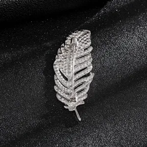Detailed back view of a silver vintage feather brooch showing the secure pin closure.
