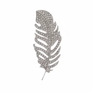 Detailed macro view of a silver-colored feather brooch paved with sparkling clear rhinestones