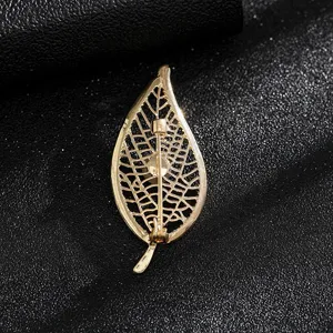 Close-up view of the back and pin mechanism of this elegant gold hollow leaf brooch