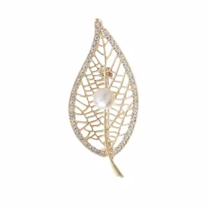 Detailed view of elegant gold-toned leaf brooch with white pearl and sparkly rhinestones