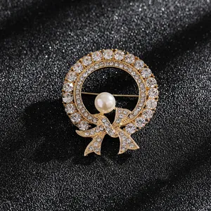 Close-up detail of vintage elegant bow brooch with sparkling rhinestones and pearl