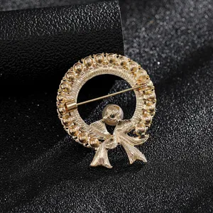 Close-up back view of gold wreath brooch showing pin fastener and fine metal texture