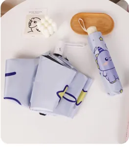 Détail d'un parapluie pliable violet clair avec des motifs de dinosaures mignons