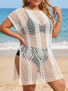 Detailed view of white crochet plus size beach cover-up dress worn by a model at beach