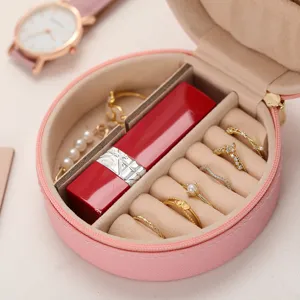 Élégante boîte à bijoux ronde rose avec fermeture éclair pour bagues et accessoires