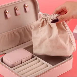 Elegant pink leather jewelry storage box with drawstring pouch and small travel case insert