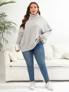 Detailed shot of casual oversized turtleneck knit sweater in indoor lifestyle setting.