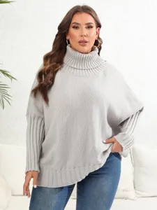 Close-up detail of the cozy solid turtleneck knit sweater showing soft ribbed texture and loose fit.