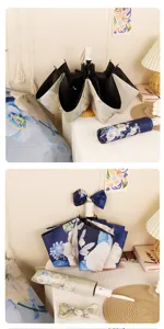 Detailed view of foldable floral sun umbrella, elegant peony pattern and matching storage bag.