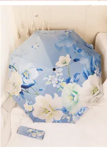 Blue floral folding sun umbrella with UV protection and black glue coating for daily use