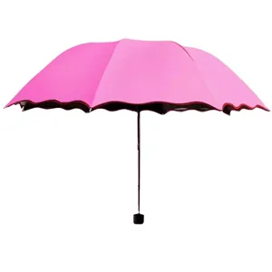 Pink folding umbrella with a unique wavy lotus leaf edge design for sun and rain protection