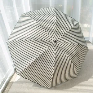 Black and white striped folding umbrella, UV protection parasol for sunny and rainy days.