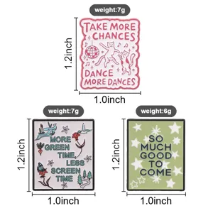 Detail showing three metal enamel pins with motivational quotes, dimensions, and weight.