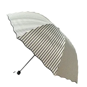 Black and white striped foldable sun umbrella with UV protection and scalloped edge design.