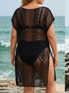 Close-up back view of a plus size black crochet beach cover-up dress for women at seaside