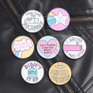 Collection of seven colorful mental health awareness enamel pins on a black leather jacket
