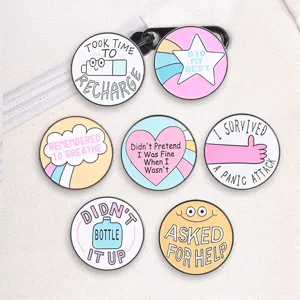 Close-up of pastel macaron mental health healing enamel badges on white canvas