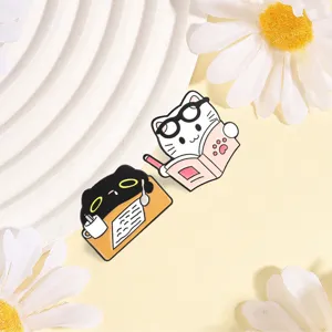 Macro view of cute cartoon white and black cat enamel pins for students schoolbag